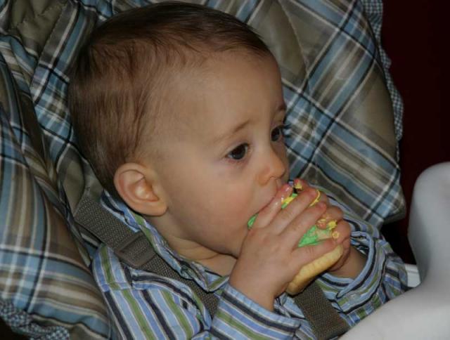 Trying to shove the whole cupcake in his mouth at once