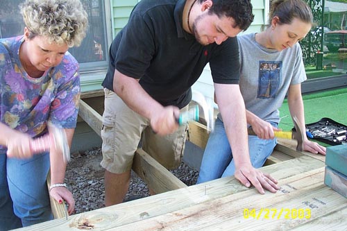 Jake, Janet, and Abby - nailing down boards - no nail gun for us!