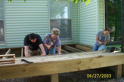 Jake, Janet, and Abby - nailing down boards - no nail gun for us!