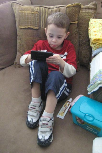 Looking like a big boy with Daddy's iPod ~ April 1, 2009