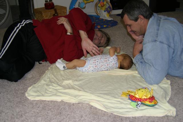 Practicing rolling over with a lot of help from Gammy & Papa Joe! ~ January 28, 2006