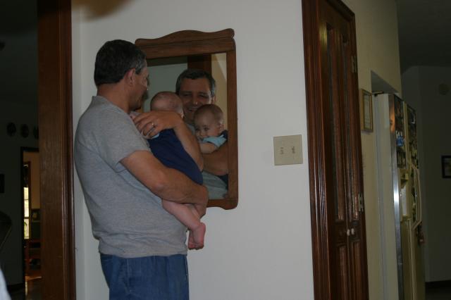 Checking out the baby in the mirror with Papa Joe ~ May 9, 2006
