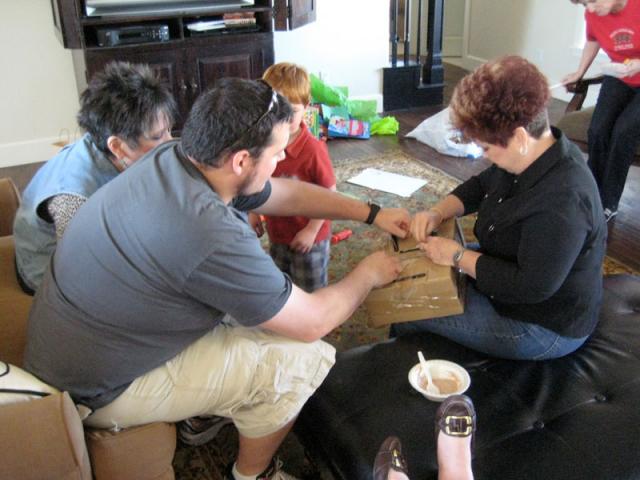 How many adults does it take to get a kid's toy out of the box?
