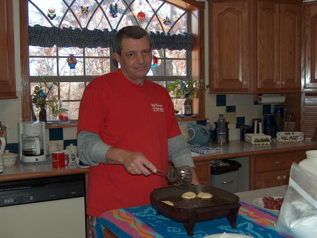 Papa Joe cooking beignets (or "benyays," according to John) for Christmas breakfast