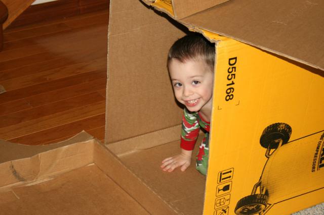 Playing in his box fort