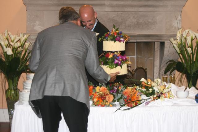 The wedding photographer keeping the cake from falling over