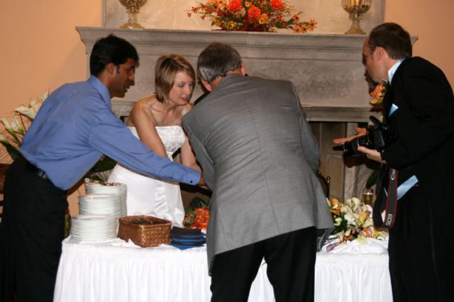 How many people does it take to cut a slice of wedding cake?