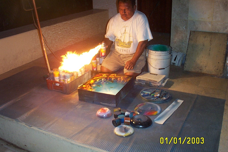 Mexican spray-painting artist, speed-drying his work...