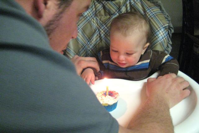 Making a wish... and Daddy holding his hands down so he doesn't catch himself on fire.