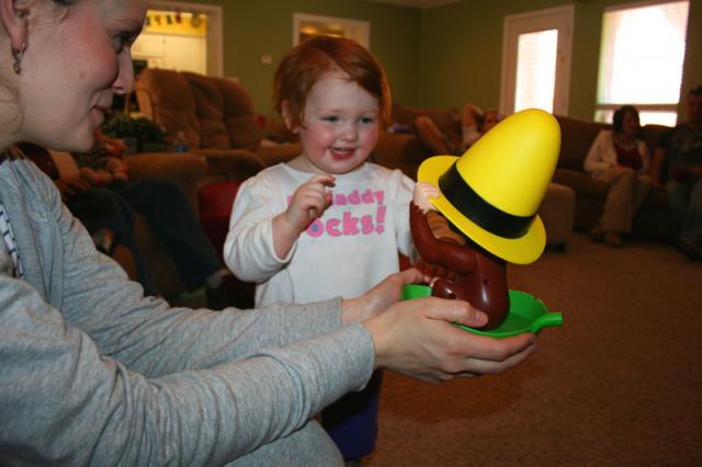 Elyn giggling at Curious George