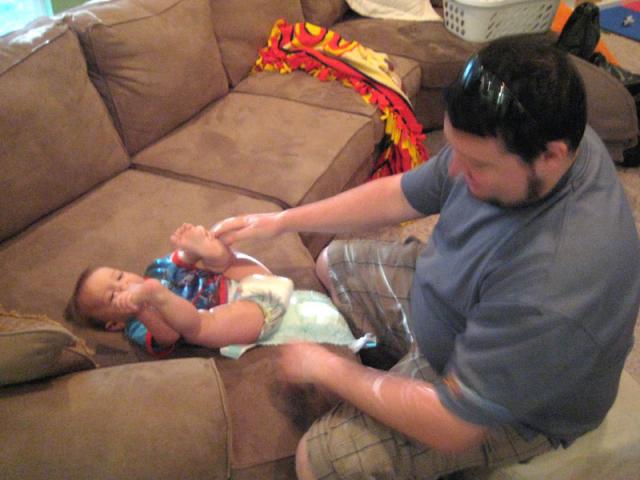 Daddy comes home for breakfast and just in time for a diaper change
