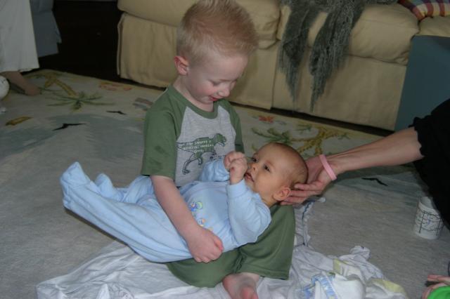 The oldest cousin holding the youngest!